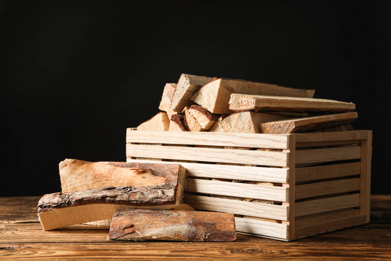 cut kiln dried firewood on a table against black background